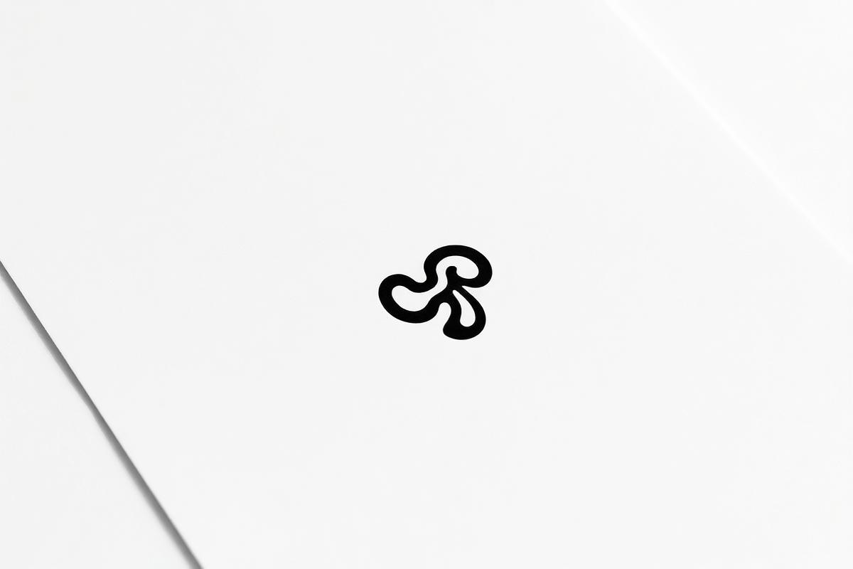 Minimal black logo mark printed on white paper